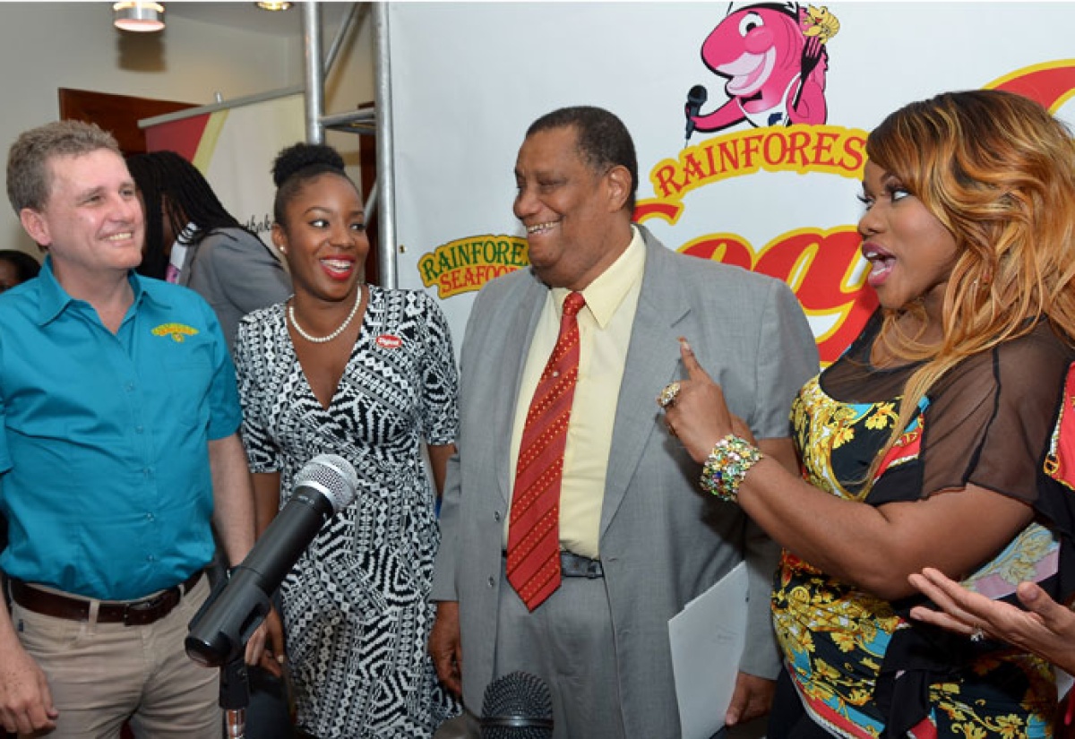 Minister of Agriculture and Fisheries, Hon. Roger Clarke (2nd right), enjoys a light moment with (from left): Chief Executive Officer of Rainforest Seafoods, Brian Jardim; Senior Sponsorship Manager at Digicel, Tahnida Nunes; and Radio personality, Miss Kitty, at the launch of the Rainforest Seafoods Festival on February 11, at Rainforest’s Slipe Road offices in Kingston.  