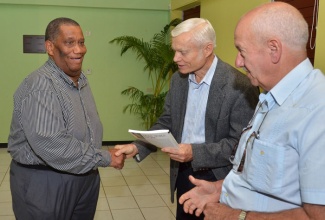 Agriculture and Fisheries Minister, Hon. Roger Clarke (left), greets Director of International Marketing for Vitazyme, Robert Haduk (centre), during a stakeholders seminar at the Agriculture Ministry’s Research Station at Bodles, Old Harbour, St. Catherine, in January. Mr. Clarke was guest speaker at the sensitization forum which was held under the theme: ‘Improving Crop Production, Increasing Productivity’.  Looking on is Director of Latin American and Caribbean Operations for the product, Dr. Juan Carlos Diaz.