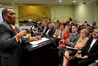 Minister of Agriculture and Fisheries, Hon. Roger Clarke (at podium), addresses members of the Diplomatic Corps, at the Courtleigh Hotel, New Kingston, on February 5, as part of activities for Diplomatic Week 2014. 