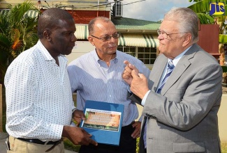 Industry, Commerce, Agriculture and Fisheries Minister, Hon. Karl Samuda (right), emphasises a point during discussion with Chief Executive Officer (CEO) of the Mavis Bank Coffee Factory Limited and Secretary of the Jamaica Coffee Exporters Association, Norman Grant (left); and Chairman of the Bureau of Standards Jamaica (BSJ), James Rawle. Occasion was the launch of the Jamaican standard specification for coffee, JS 61:2016, at the BSJ headquarters in St. Andrew on February 1.  