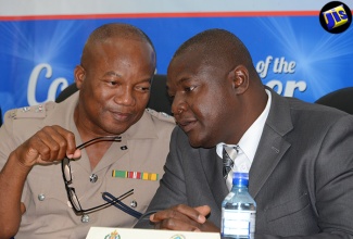 Senior Superintendent and Commanding Officer of the Traffic and Highway Division, Jamaica Constabulary Force (JCF), Calvin Allen (left), in discussion with Director, Island Traffic Authority, Ludlow Powell, during a press conference at the Office of the Police Commissioner in St. Andrew, on July 11.