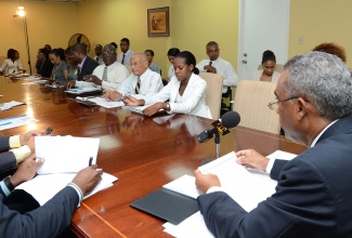 Permanent Secretary in the Ministry of Foreign Affairs and Foreign Trade, Ambassador Paul Robotham (right), addressing representatives of the private and public sectors at a meeting held on Tuesday, June 25, at the Ministry of Foreign Affairs and Foreign Trade in New Kingston, to get the input of key stakeholders ahead of a special session of the Caribbean Community (CARICOM) Council for Trade and Economic Development (COTED).