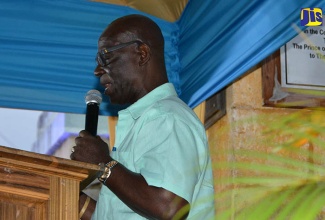 Minister of Local Government and Community Development, Hon. Desmond McKenzie, addresses a community function in Water Square, Trelawny, on April 27.