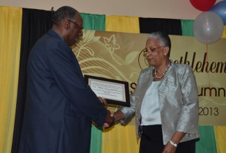 Retired Chief Medical Officer of  Health (CMO), Dr. Sheila Campbell-Forrester (right), receives a plaque from President of the Alumni of the St. Elizabeth based Bethlehem All Age and Infant School, Frank Marshall, on August 17, at a re-union dinner, held at the Bethlehem  Moravian College, in Malvern.