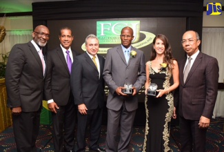 Minister without Portfolio in the Ministry of Economic Growth and Job Creation, Hon. Dr. Horace Chang (right), shares a photo opportunity with (from left) Managing Director of the Factories Corporation of Jamaica (FCJ), Dr. Donald Farquharson; FCJ Chairman, Lyttleton Shirley; President of the Jamaica Manufacturers Association (JMA), Metry Seaga; FCJ long-service awardee, Dexter Hunter; and client of the agency and Managing Director of King Pepper, Christine Wong. Occasion was the FCJ’s 30th Anniversary Awards Banquet held on October 21 at The Jamaica Pegasus hotel in New Kingston.