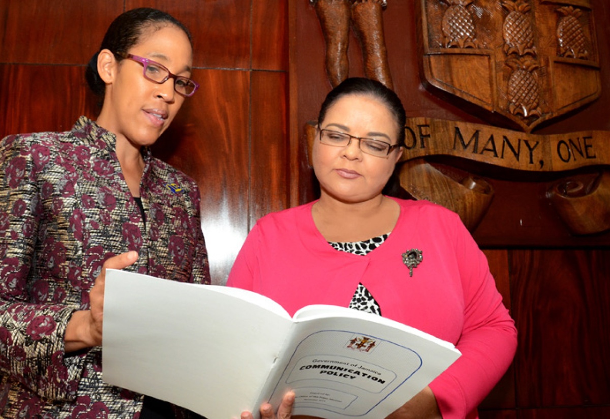 Minister with responsibility for Information, Senator the Hon. Sandrea Falconer (right), listens to a point being made by Chief Executive Officer (CEO) of the Jamaica Information Service about the newly launched Government of Jamaica Communication Policy. Minister Falconer officially launched the document during a Government Communicators’ Meeting, at the Office of the Prime Minister, on Thursday, December 10.