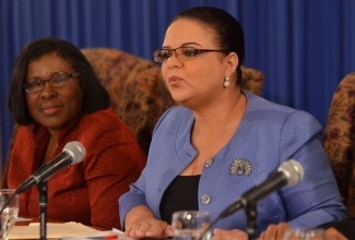 Information Minister, Senator the Hon. Sandrea Falconer addresses members of the media, during a Jamaica House press briefing, held at the Office of the Prime Minister on September 18. Also pictured is: Permanent Secretary in the Ministry of Transport, Works and Housing, Audrey Sewell.
