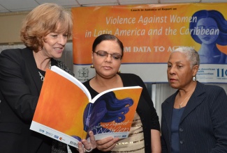 Minister with responsibility for Information, Senator the Hon. Sandrea Falconer (centre), discusses an aspect of  a report entitled: ‘Violence Against Women in Latin America and the Caribbean’, with Pan American Health Organization/World Health Organization (PAHO/WHO) Representative in Jamaica, Margareta Sköld (left) and Permanent Secretary in the Ministry of Health, Dr. Jean Dixon. Minister Falconer officially launched the report during a ceremony at the Jamaica Pegasus Hotel in Kingston on March 26. 