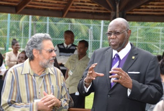 Minister of Health, Hon. Dr. Fenton Ferguson (right), speaks with Dr. John Peter Figueroa, shortly before the start of the opening ceremony for the 29th Caribbean Expanded Programme on Immunization (EPI) Managers Meeting/Conference at the Jewel Runaway Beach and Golf Resort in St. Ann on November 19. 
