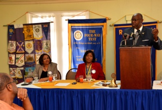 Minister of Health, Hon. Dr. Fenton Ferguson (right), addressing Rotary Club of St. Andrew meeting at the Hotel Four Seasons in Kingston on November 26. Others (from left) are: Past President of the Club, Jennifer Anderson and President, Marie Powell.