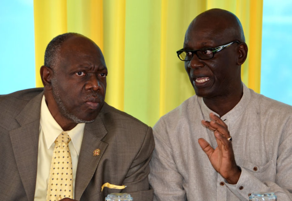 Minister of Health, Hon. Dr. Fenton Ferguson (left), listens to a point being made by Member of Parliament for Western Kingston, Desmond McKenzie during the official re-opening ceremony for the Charles Chin Loy Health Centre in Western Kingston on Thursday, November 28.