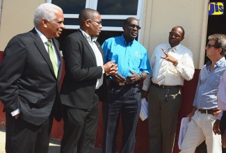 
Education, Youth and Information Minister, Senator the Hon. Ruel Reid (centre), speaks with Principal of the Newell High School, in St. Elizabeth, Paul Grant (second right), during a visit to the institution recently. Others (from left) are Councillor for the Pedro Plains Division of the St. Elizabeth Parish Council, Jeremy Palmer; Minister of State in the Ministry of Education, Youth and Information, Hon. Floyd Green   and Chairman of the Newell High School Board, Jason Henzell.
