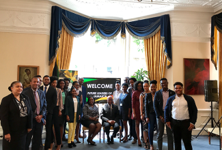 High Commissioner to the United Kingdom (UK), His Excellency Seth Ramocan (seated 10th right); Deputy High Commissioner,  Angella Rose Howell (seated 11th left); and Counsellor, Political and Economic Affairs, Carol Lee-Lea (left), share a photo opportunity with Jamaican scholars in the UK at a special luncheon at the High Commission in London on July 6. 