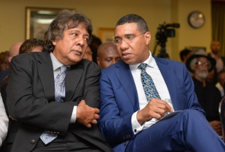 Prime Minister, the Most Hon. Andrew Holness (right), is in discussion with Executive Chairman, Guardsman Group, Kenneth Benjamin, during a security forum organised by Guardsman Group at The Knutsford Court Hotel in New Kingston on May 11.