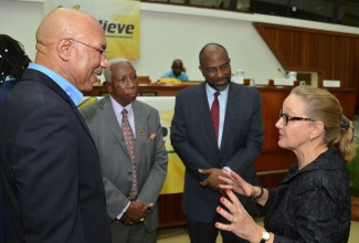 Governor-General, His Excellency the Most Hon. Sir Patrick Allen (left), listens attentively to a point being made by President and Chief Executive Officer, Toon Boom Animation, Joan Vogelesang (right), following the opening ceremony of the ‘I Believe’ National Youth Consultative Conference on October 24, at the Jamaica Conference Centre, downtown Kingston. Also listening are: National Coordinator, Governor-General’s Youth Achievement Awards, Hugh Morris (2nd left); and General Manager, Jamaica National Building Society, Earl Jarrett.