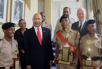 Governor-General, His Excellency, the Most Hon. Sir Patrick Allen (2nd left), with (from left):  members of the Jamaica Combined Cadet Force (JCCF), Corporal Xuandre Mohansingh of the Fifth Battalion; Sergeant Cleveland Palmer of the Second Battalion and Corporal Nichola Perkins of the Third Battalion, at the launch of  Wings Appeal 2015, at King’s House, on September 8. The Governor-General presented trophies to the cadets for helping to raise funds for World War  II veterans. Others in the background (from left) are:  Chairman of  the Royal Air Force Association (RAFA), Jamaica Branch, Major Johanna Lewin; Commandant of the JCCF, Colonel Lemuel Lindo; Pilot, Captain Lewis Mayne; and President of  RAFA, Major General Robert Neish.