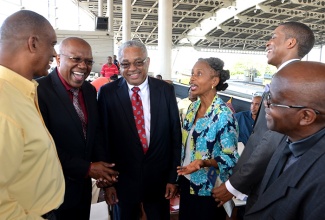 Minister without Portfolio, Ministry of Transport, Works, and Housing, Hon. Dr. Morais Guy (left), shares a joke with (from left): Jamaica Urban Transit Company (JUTC) Chairman, Rev. Dr. Garnett Roper; University of the West Indies (UWI) Pro-Vice Chancellor and Principal of UWI Mona,  Professor Archibald McDonald; Mona Campus Registrar, Dr. Camille Bell-Hutchinson; third year student in the Department of Computing, UWI Mona, Oswald Smith; and Department Head, Dr. Ezra Musiga. Occasion was the launch of the JUTC’s Google Transit technology application, developed by Mr. Smith, at the Half-Way-Tree Transport Centre on Tuesday (August 25). 