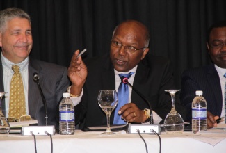 Minister without portfolio in the Ministry of Transport, Works and Housing, Hon. Dr. Morais Guy (centre), addresses the opening of the International Civil Aviation Organization’s (ICAO) council meeting on Monday (October 12), at the Iberostar Hotel in Lilliput, St. James.  Listening are Regional Director of the ICAO, Melvin Cintron (left); and  President of the ICAO, Dr. Bernard Alui. 