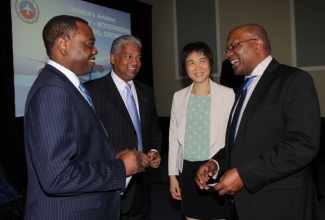 Minister without Portfolio in the Ministry of Transport, Works and Housing, Hon. Dr. Morais Guy (right), converses with (from left): President of the International Civil Aviation Organization (ICAO), Dr. Olumuyiwa Benard Aliu; Director General of the Jamaica Civil Aviation Authority (JCAA), Nari Williams-Singh; and ICAO Secretary General, Dr. Fang Liu. Occasion was the meeting of  the ICAO Council at the Iberostar Hotel in Lilliput, St. James earlier this week. 