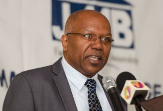 Minister without Portfolio in the Ministry of Transport, Works and Housing, Hon. Dr. Morais Guy,  addresses a recent forum hosted by the Jamaica Mortgage Bank, in Kingston, where he informed stakeholders about the latest amendments to the Mortgage Insurance Act.  