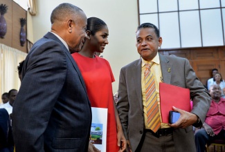 Minister of Local Government and Community Development, Hon. Noel Arscott (right), converses with Minister of Youth and Culture, Hon. Lisa Hanna (centre), and Minister of Labour and Social Security, Hon. Derrick Kellier, at the  launch of Workers’ Week, and Labour Day, at Jamaica House, on Wednesday, May 7.