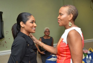 Minister of Youth and Culture, Hon. Lisa Hanna (left), is greeted by Board Chairman of the National Youth Service (NYS), Maureen Webber, when she arrived at the Courtleigh Hotel in Kingston, on February 6, to participate in the official launch of  the NYS’ Graduate Work Experience Programme (GWEP).