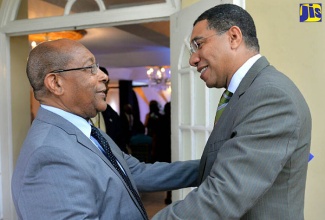 Prime Minister, the Most Hon. Andrew Holness (right), is warmly greeted by Eden Gardens Group of Companies Executive Chairman, Dr. Henry Lowe, on arrival at the Eden Gardens Wellness Resort and Spa in St. Andrew on Wednesday, July 12, for a ceremony to announce the United States Food and Drug Administration’s (FDA) designation of Orphan Drug Status for ‘Chrysoeriol’. The drug, derived from cannabis, was developed by the United States-based Flavocure Biotech LLC (FBL), to treat acute myeloid leukaemia (AML). Flavocure Biotech LLC is owned and operated by the Eden Gardens Group.