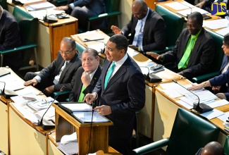 Prime Minister, the Most. Hon. Andrew Holness (right), makes his contribution to the 2017/18 Budget Debate in the House of Representatives on March 21. At left is Minister without Portfolio in the Ministry of Economic Growth and Job Creation, Hon. Dr. Horace Chang and at second left is Minister of Finance and the Public Service, Hon. Audley Shaw.