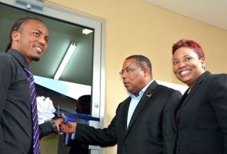 Minister  of Industry, Investment and Commerce, Hon. Anthony Hylton (centre) is joined by President of the Montego Bay Free Zone Sports Committee, Jason Shurriah (left) and Columbus Business Solutions (CBS) Director of Corporate Communications,   Gail Abrahams as he declares the Montego Bay Free Zone Engagement Centre officially open on Friday, May 2. The facility which is the first of its kind in a Jamaican free zone, is a newly refurbished space consisting of 630  square feet. The project was funded through a partnership between the Montego Bay Freezone and Columbus Business Solutions (CBS), while Singer Jamaica, provided the furniture and appliances.