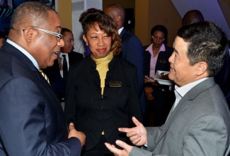 Minister of Industry, Investment and Commerce, Anthony Hylton (left) shares a light moment with Ambassador of the People’s Republic of China to Jamaica, His Excellency, Dong Xiaojun; and President of Jamaica Promotions Corporation (JAMPRO), Diane Edwards, during JAMPRO’s 25th anniversary ‘business mixer’ held on Wednesday, May 8 at its head offices in Kingston. 