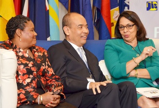 Minister of Labour and Social Security, Hon. Shahine Robinson (right), in conversation with (from left), President of the Caribbean Congress  of Labour, Jennifer Isaacs-Dotson; and President of the Caribbean Employers’ Confederation, Wayne Chen, during the opening ceremony for the Caribbean Future of Work Forum, held  at The Jamaica Pegasus hotel on February 22.