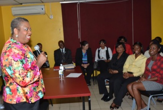 Motivatonal speaker,  Dr. Nsombi Jaja (left), addresses Jamaica Information Service (JIS) employees  at a special staff meeting held on September 18 at the agency’s head office in Kingston. The meeting was held to welcome a five-member delegation from Botswana, who is in the island to benchmark with the government agency. 