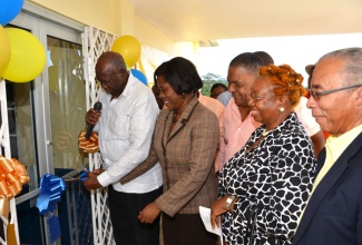 Health Minister, Hon. Dr. Fenton Ferguson (left), is assisted by Acting Chairperson, Southern Regional Health Authority (SRHA), Natalie Sparks (2nd left), to cut the ribbon to officially open the new James Hill Health Centre in North Clarendon, on January 24. Sharing the moment are: Minister without Portfolio, Ministry of Finance and Planning, and Member of Parliament for  the area, Hon. Horace Dalley (centre); Winsome Gregory (2nd right), who represented Clarendon’s Custos,  Hon. William Shagoury; and National Health Fund (NHF) Chairman, Sterling Soares.