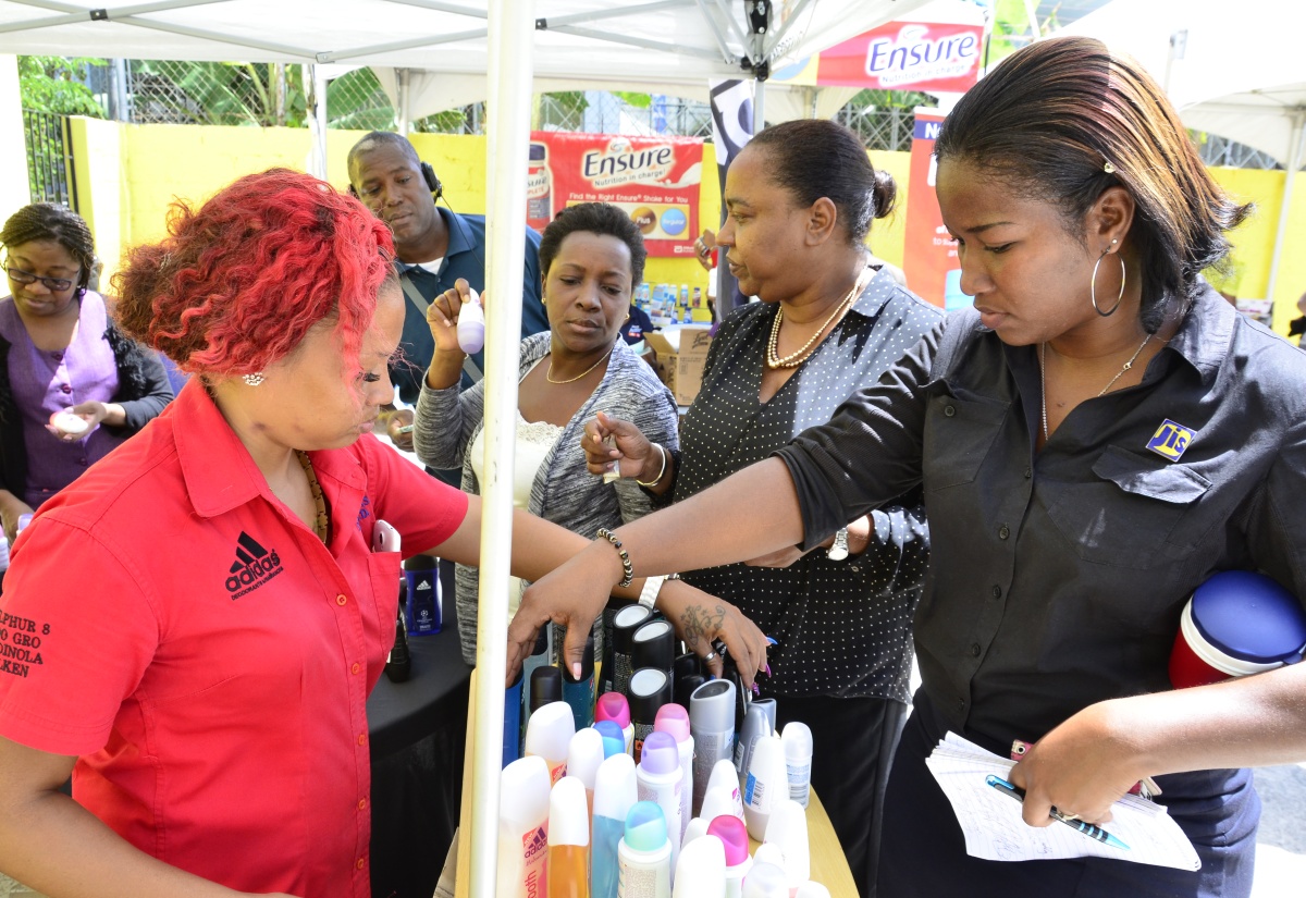 Jamaica Information Service (JIS) employees examine products on display at the Adidas booth during the Jamaica Fitness Association’s (Jamfit) Company Tour held at the agency’s head office in Kingston on September 15. The initiative is aimed at promoting  a healthy lifestyle. 