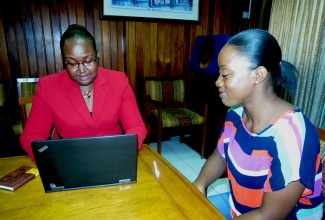 Chief Education Officer, Dr. Grace McLean (left), in discussion with Dr. Kadene Arboine, who recently completed medical school through assistance from the Ministry of Education. Kadene stopped by the Ministry’s Heroes Circle head office in Kingston on August 12, to express thanks for the help she received.