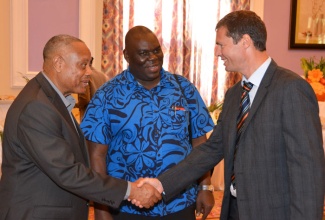 Minister of Agriculture, Fisheries, Labour and Social Security, Hon. Derrick Kellier (left), is introduced to representative of the European Union (EU) Delegation in Jamaica, Thomas Opperer (right), by Permanent Secretary in the Agriculture and Fisheries Ministry, Donovan Stanberry, on the second day of the Jamaica Association of Sugar Technologists (JAST) two-day annual conference, on Friday, November 7, at the Riu Hotel and Resort in Ocho Rios, St. Ann. Mr. Kellier addressed delegates and guests attending the conference, which was held under the theme, 'Positioning for Increased Cane and Sugar Production'.