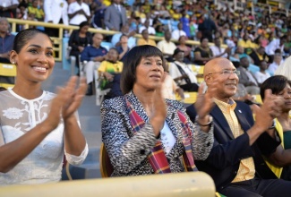 Governor-General, His Excellency the Most Hon. Sir Patrick Allen (third left) and  Lady Allen (right), applaud a performance at the Grand Gala, held at the National Stadium on August 6.  Also applauding (from left) are:  Minister of Youth and Culture, Hon. Lisa Hanna, and Prime Minister, the Most Hon. Portia Simpson Miller.