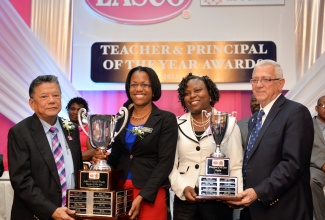 Education Minister, Hon. Rev. Ronald Thwaites (right), presents the Principal of the Year trophy to Kandi-Lee Crooks-Smith (2nd right) of Allman Town Primary School, while  Founder and Executive Chairman of LASCO Affiliated Companies, Hon. Lascelles Chin, makes the Teacher of the Year trophy presentation to Nickashie Hardware of York Castle High School. Occasion was the 2015/2016 LASCO/ Ministry of Education Teacher and Principal of the Year Awards ceremony held on November 24 at the Pegasus Hotel in New Kingston.