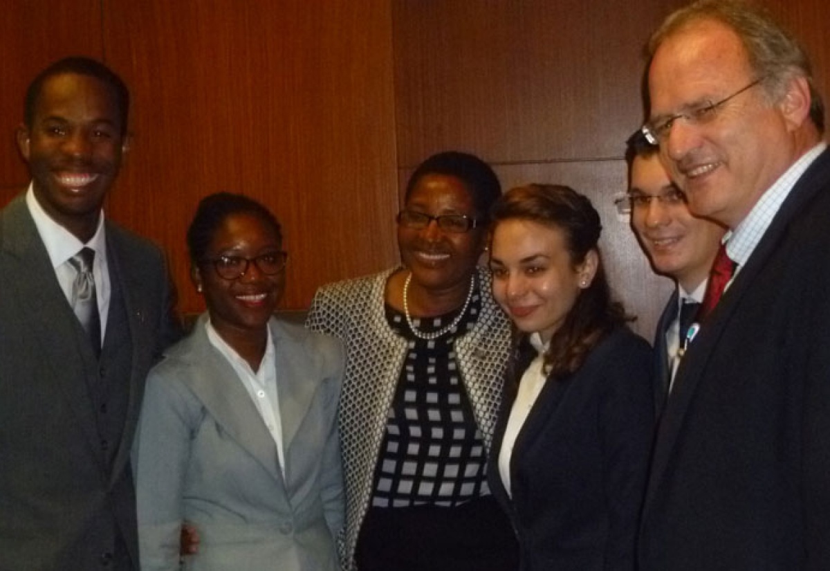 Final year Norman Manley Law School students, Ralston Dickson (left) and Donia Fuller (2nd left), share a moment with Madam Justice Bess Nkabinde (3rd left) of the Constitutional Court of South Africa; United Nations Special Rapporteur on extrajudicial, summary or arbitrary executions, Professor Christof Heyns (right), and  members of the West University of Timisoara team. Occasion was the finals of the 5th World Human Rights Moot Court Competition held on December 10 at the University of Pretoria in South Africa, where Norman Manley took the top prize for the fourth consecutive year.