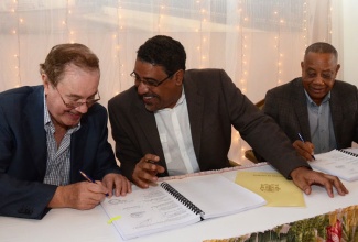 Tourism and Entertainment Minister, Hon. Dr. Wykeham McNeill (centre), converses with Chairman of Europe’s third largest hotel chain, Melia Hotels International (MHI), Gabriel Escarrer Julia (left), during the signing of an agreement between MHI and the National Insurance Fund (NIF) for the provision of upwards of 400 jobs at the Braco Hotel in Trelawny which MHI will operate over the next 15 years. The signing took place at the Braco Hotel on November 21. Arrangement for the jobs were finalized following discussions involving Dr. McNeill; Labour and Social Security Minister, Hon. Derrick Kellier (right), under whose portfolio the NIF falls; and Mr. Julia.