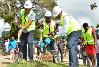 Minister of Health and Member of Parliament for West Central St. Catherine, Dr. the Hon Christopher Tufton (left), takes part in the breaking of ground for the $49-million expansion of the Brown’s Hall Primary School in the parish on December 20. The $49-million project is being undertaken by the Jamaica Social Investment Fund (JSIF).  Principal of the school, Barrington Mighton (centre); and Managing Director of JSIF, Omar Sweeney, also participate in the ground breaking.