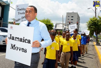 In this file photo, Minister of Health, Dr. the Hon. Christopher Tufton (left), leads a mini march outside Gordon House, downtown Kingston, in June 2016, to promote the Government’s ‘Jamaica Moves’ (#JaMoves) national campaign. 