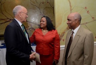 Minister with responsibility for Sport, Hon. Natalie Neita Headley (centre), is in discussion with President, Jamaica Olympic Association, Michael Fennell (left) and General Secretary, Jamaica Olympic Association, Christopher Samuda, during a forum on safeguarding and protecting children in sport, at the Courtleigh Hotel and Suites in Kingston on October 9.