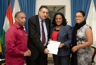 Minister with responsibility for Sports, Hon. Natalie Neita Headley (2nd right), accepts a cheque valued at US1.33 million, for the Sabina Park Lighting project, from Charge de Affairs at the Indian High Commission, H.K. Mohan. The presentation was made during a brief ceremony today (July 10), at Jamaica House. Also in attendance were Chairman, Sabina Park Holdings, Milton Samuda; and Permanent Secretary, Office of the Prime Minister, Onika Miller.