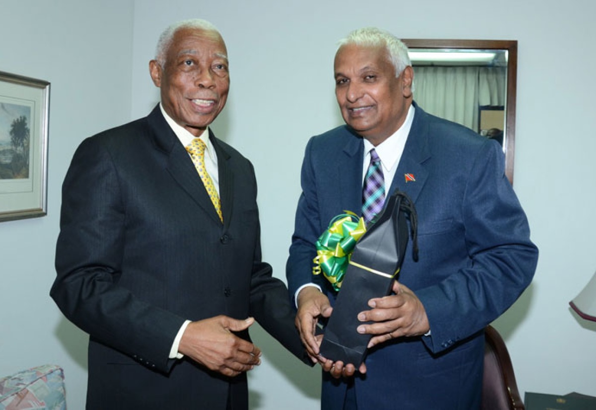 Minister of Foreign Affairs and Foreign Trade, Senator the Hon. A. J. Nicholson (left), presents his Trinidad and Tobago counterpart, Hon. Winston Dookeran, with a gift, during a press briefing at the Ministry’s New Kingston offices on December 3. The Ministers have concluded two days of bilateral talks on issues of free trade and free movement within the context of the Caribbean Single Market and Economy (CSME). 