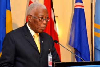 Minister of Foreign Affairs and Foreign Trade, Senator the Hon. A.J. Nicholson, addresses the opening session of the 3rd meeting of the Caribbean Development Roundtable, being held at the Jamaica Pegasus hotel in New Kingston from April 23 to 24. The event is hosted by the Economic Commission of  the Latin American and Caribbean (ECLAC) sub-regional headquarters for the Caribbean, in collaboration with the Ministry of Foreign Affairs and Foreign Trade.