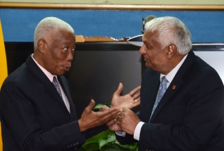 Minister of Foreign Affairs and Foreign Trade, Senator the Hon. A.J. Nicholson (left), and his Trinidad and Tobago counterpart, Hon. Winston Dookeran, are in light discussion prior to the start of a meeting at the Ministry’s New Kingston offices on December 2, to discuss issues of free movement and free trade within the context of the Caribbean Single Market and Economy (CSME). 