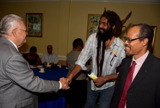 P8- Minister of Industry, Commerce, Agriculture and Fisheries, Hon. Karl Samuda (left), is being greeted by Operations Director of B and D Trawling Limited, Sean Francis (centre), at the opening of the 15th meeting of the forum at The Knutsford Court Hotel in New Kingston on March 30. Looking on is Executive Director of the Caribbean Regional Fisheries Mechanism (CRFM), Milton Haughton.