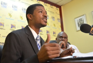 Deputy Managing Director for Operations at the Jamaica Urban Transit Company (JUTC), Kirk Finnikin (left) addresses a Jamaica Information Service (JIS) 'Think Tank' session at the agency's headquarters in Kingston on August 21. Looking on is JUTC's Managing Director, Colin Campbell.