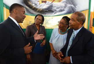 Science, Technology, Energy and Mining Minister, Hon. Phillip Paulwell (left),  emphasizes a point during a discussion with Executive Director, Council of Community Colleges of Jamaica (CCCJ), Dr. Donna Powell-Wilson (2nd left); Principal, Excelsior Community College (ECC), Dr. Nadine Scott (2nd right); and ECC Management Committee Chairman, Morin Seymour, during Tuesday’s (February 11) launch of activities commemorating ECC’s 40th anniversary, at the institution’s main campus on Mountain View Avenue, Kingston. 